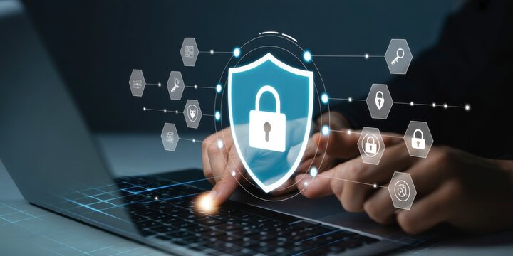 Cyber Shield: An illuminated shield with a lock, symbolizing robust protection, hovers over a laptop, with hands interacting with the device.