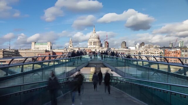People Walking On Millennium Bridge towards St. Paul's Cathedral In London.
