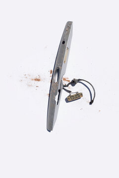 Discarded plastic car parts on solid white background