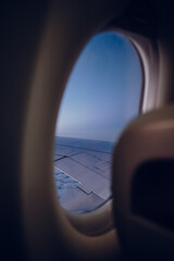 Fototapeta premium Airplane View with Wing Above the Clouds – Window Seat Perspective