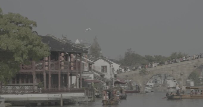 Elegant Stone Arch Bridge with Rowing Boats and Tourist Crowds Above. Zhujiajiao, Shanghai, China