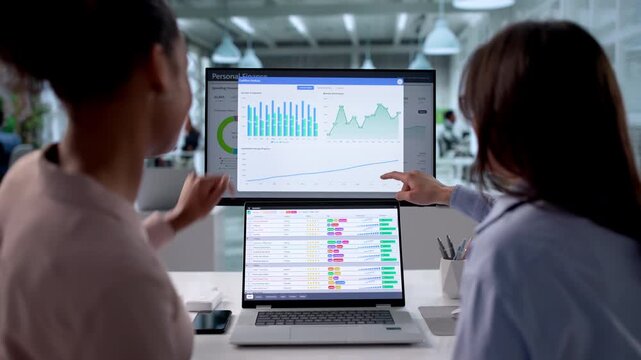 Women Conducting Business Audit With Spreadsheets