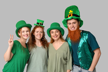 Group of people in hats on light background. St. Patrick's Day celebration
