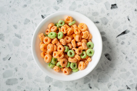 A top down view of a bowl of apple flavored cereal.