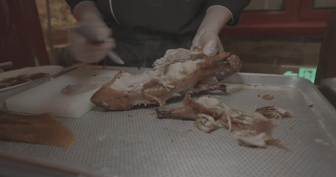 Roasted Peking duck dish being prepared for serving to guests