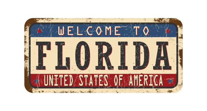 Welcome to Florida. An old worn sign with an inscription. Welcome metal plaque with rust elements