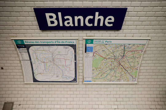 Blanche metro station sign with Paris transport maps on tiled wall. Paris, France - October 13, 2025.