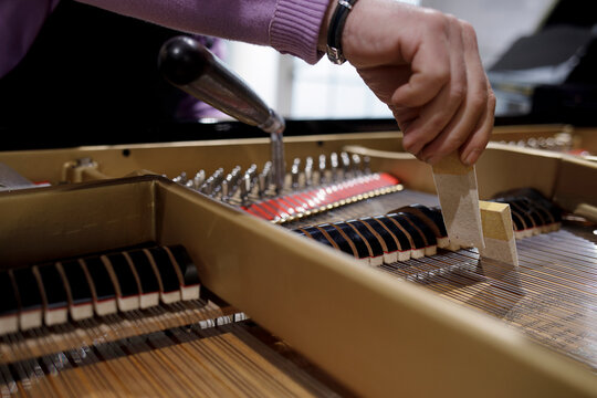 Close up of piano tuning and string maintenance