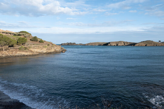 Rocky coastal bay with calm blue sea and cliffs
