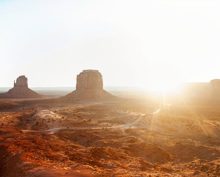 Rising sun burst on Monument Valley landscape