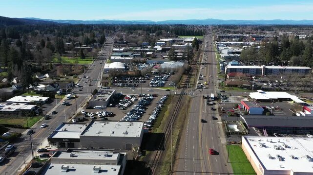 Aerial drone view of Oregon Route 8 and Route 10, Farmington Road and Tualatin Valley Highway in Beaverton Oregon USA. Major commercial corridor with heavy traffic and urban development in 4K footage.