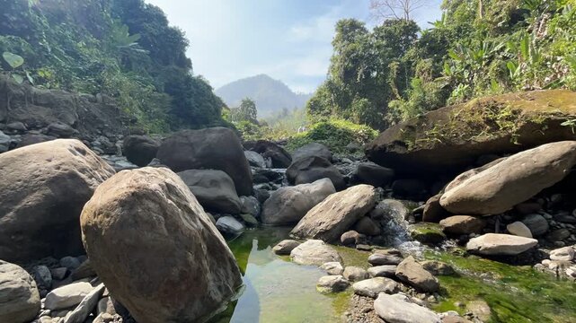 Mountain Stream Timelapse in Bandarban Bangladesh, Water Flowing over Large Boulders with Hazy Peak Background, Scenic Hill Tracts Trekking Landscape Time-lapse