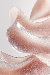 Obraz premium Shimmering pink cosmetic product flowing, abstract liquid texture background, beauty gel or serum spreading