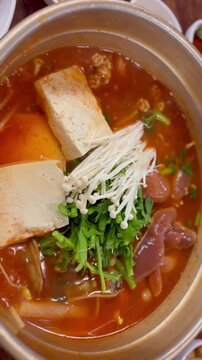 Boiling Korean spicy fish roe soup (Al-tang) with fresh pollack roe and vegetables in a stone pot