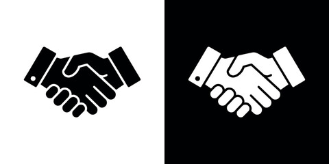 Obraz premium Black and white handshake on split background business