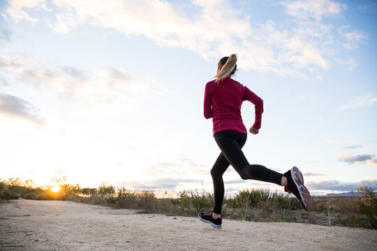 Young woman jogging alone in countryside