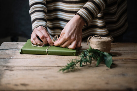 Woman's hands wrapping present