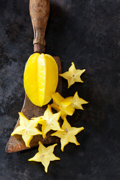 Sliced starfruit on an old cleaver