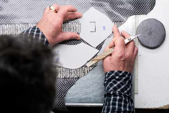 Close-up of shoemaker working on template in his workshop