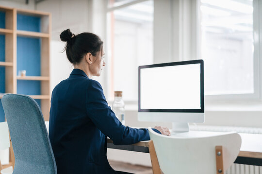 Woman working at desk in a loft