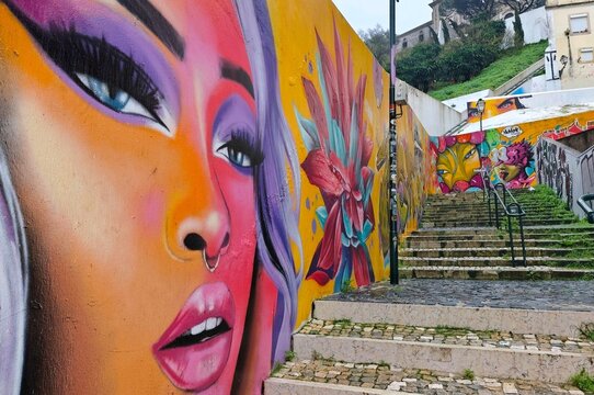 Photo of the Caracol da Graca graffiti staircase in Lisbon&rsquo;s historic Mouraria (Moorish quarter), a famous urban street art landmark connecting Mouraria and Grac