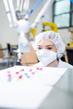 Woman watching robot handling sweets