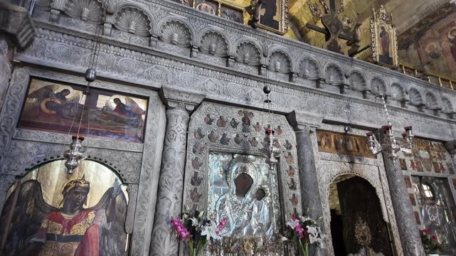 Paros Island,Tilt up from altar inside to the holy cross at Ekatontapyliani Church,Holy Shrine of Virgin Mary during day. Beautiful interior, a big decorated cross on the top of altar.
