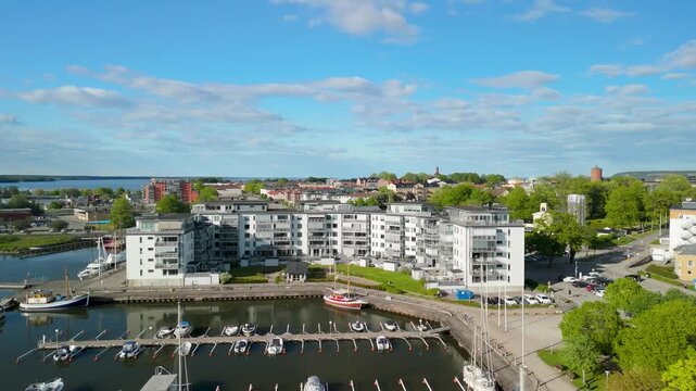 Vertical aerial view over V&auml;nersborg Hamn marina with yachts, docks and waterfront apartments by lake V&auml;nern during sunny summer day