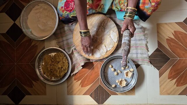 The traditional process of rolling out puran poli, a sweet flatbread popular in Maharashtra for festivals like Holi.
