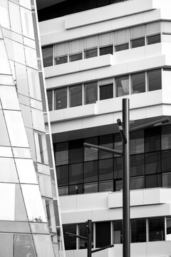 Modern urban building facade with windows in monochrome style using geometry lines for a corporate look and clean background that supports copy space branding