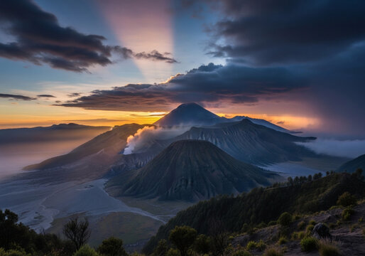 Dramatic sunrise over Mount Bromo volcano with smoking crater crepuscular rays and vibrant sky.