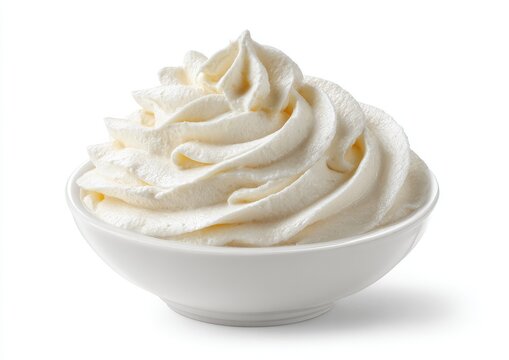 A swirl of fresh, white, whipped cream beautifully piled in a small, white bowl