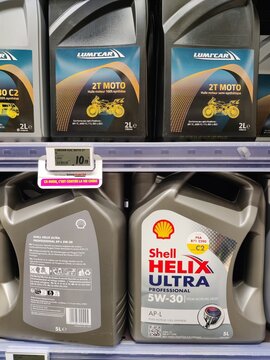 Saujon, France - January 24, 2026: Intermarche. Shell Helix Ultra 5W-30 motor oil and Lumicar 2T Moto oil displayed on a supermarket shelf with pricing label visible