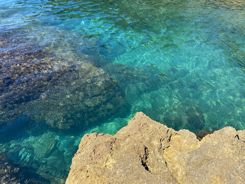 Mediterranean sea crystal clear water near the rocky shore.
