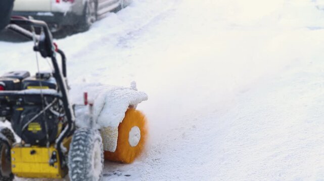 Removing snow with portable blower machine during winter, worker with gas snow blower removal in the streets after snowfall, clearing residential sidewalk driveway with snow sweeper, snowplow machine