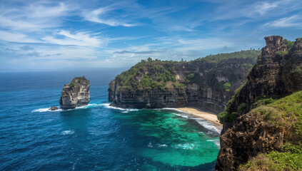 Obraz premium Turquoise sea coastal cliff tropical beach with dramatic rock formation and vivid sky