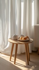Bright cozy morning table with pastries, tea and ceramics near a sunlit window