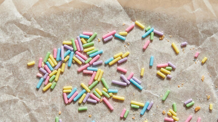 Macro Shot of Pastel Sugar Sprinkles on Wrinkled Parchment Paper