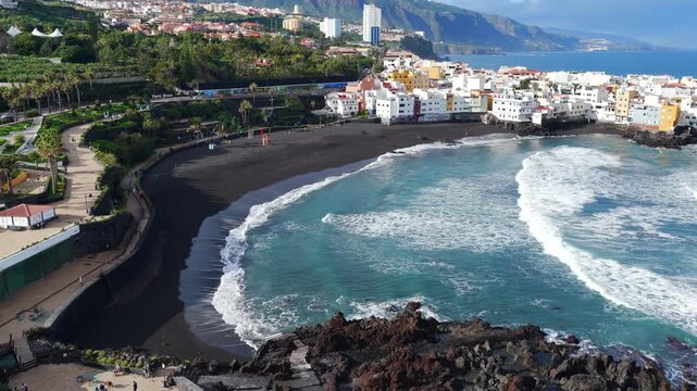 Aerial of closed beach with red flags and warning signs due to E. coli contamination and sewage discharge in Tenerife