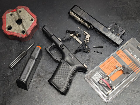 BALTIC STATES - FEBRUARY 20, 19, 2026: Disassembled Glock 19 Gen5 pistol undergoing tuning with new Glock Performance Trigger GPT kit