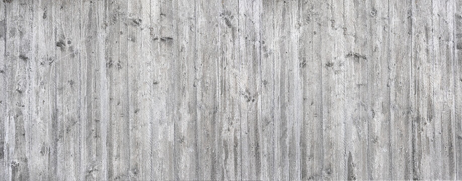 Gray concrete wall showing weathered wood grain texture