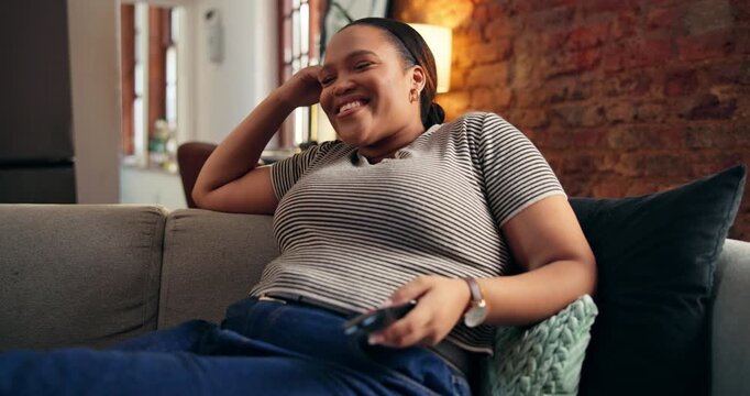 Laughing, woman and streaming with remote, lounge or watching comedy show with subscription in house. Happy, black person and relax with controller for entertainment, funny movie and humor in home