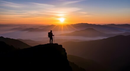Fototapeta premium Man Standing on Mountain Cliff Edge at Beautiful Sunrise