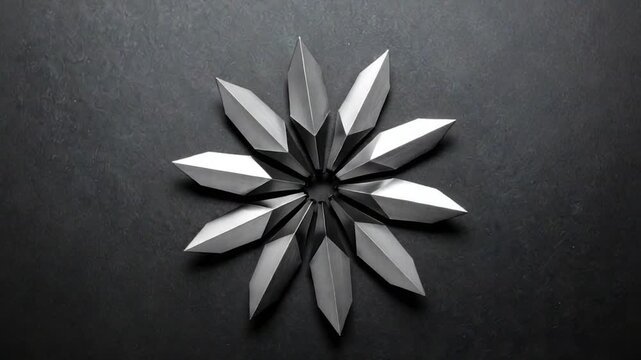 Geometric starburst made of metallic angular elements on a dark surface