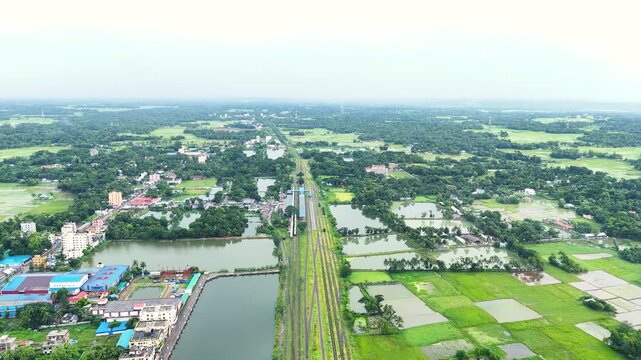 Aerial View of Railway Line Crossing Green Countryside 4K