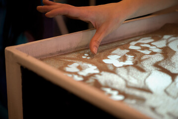 Creative Sand Art Table With Hand Drawing Soft Patterns In Warm Light Scene