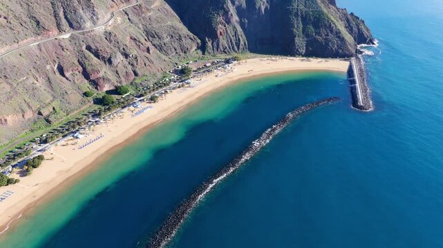 Aerial panorama of Playa de Las Teresitas golden sand beach and turquoise ocean gradients in Tenerife Canary Islands