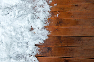 Contrast Between Fresh Snow And Warm Wooden Deck Surface