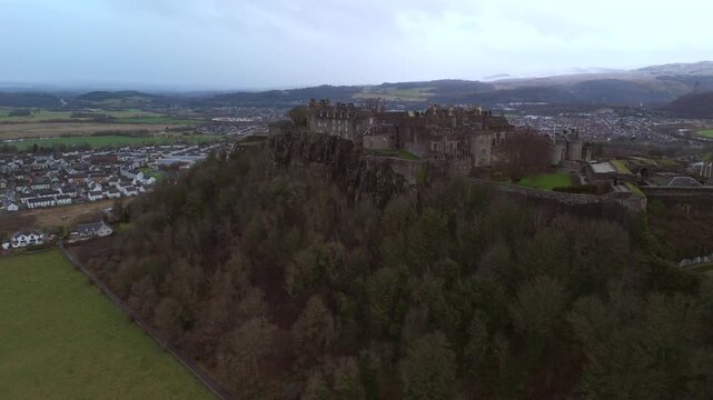 Stirling skyline with the city below and mountains in the distance. Clouds cover the sky, creating an atmosphere in Scotland