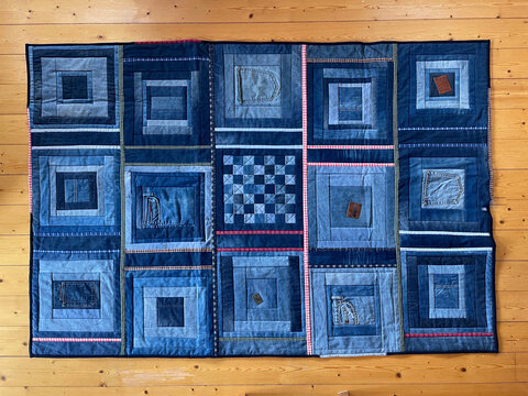 A quilted patchwork blanket of one color, completely made of recycled blue jeans fabrics